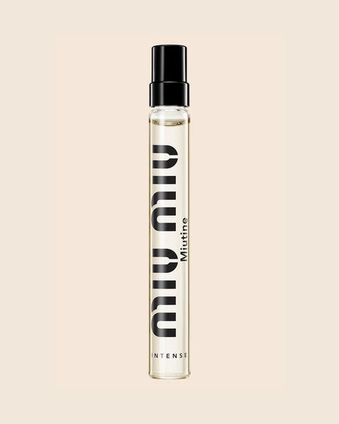 A Miu Miu Miutine Intense travel spray in a slim glass tube with a black cap.