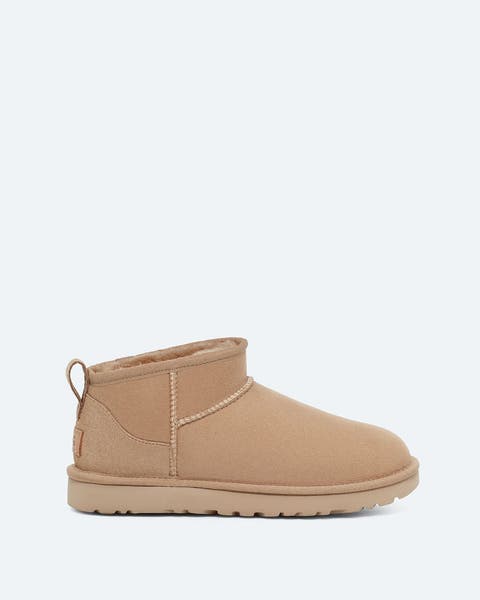 Beige ankle UGGs.