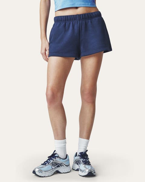A woman wearing navy blue gym shorts.