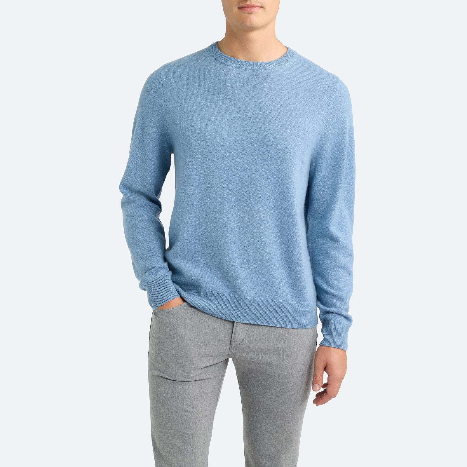 A man wearing blue crewneck sweater.