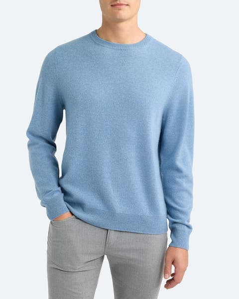 A man wearing blue crewneck sweater.