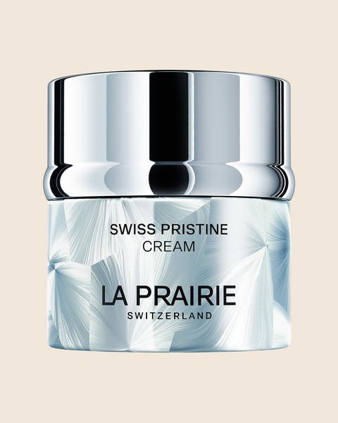 A La Prairie Swiss Pristine Cream jar with a silver lid.