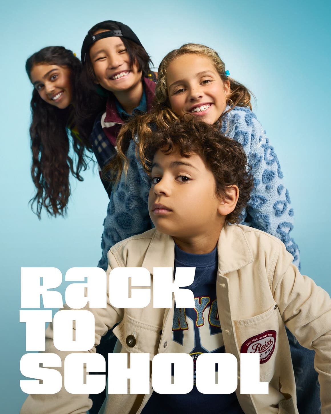 Rack to school. Four kids pose for a picture. 