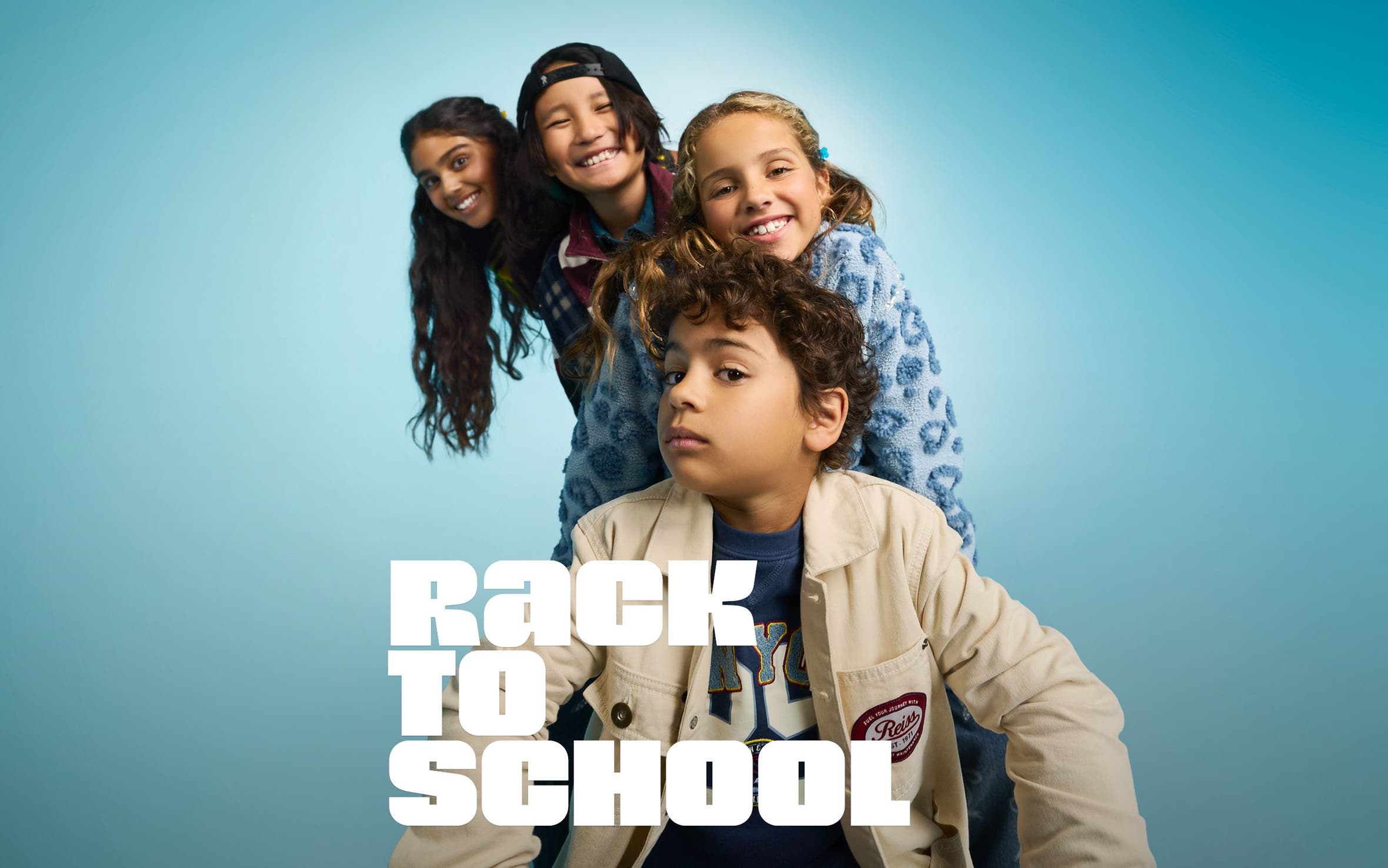 Rack to school. Four kids pose for a picture. 