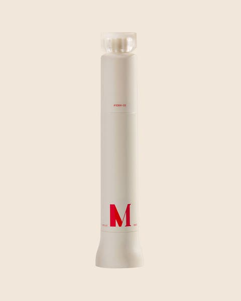 A cream cylindrical bottle with a red capital M and a frosted square cap.