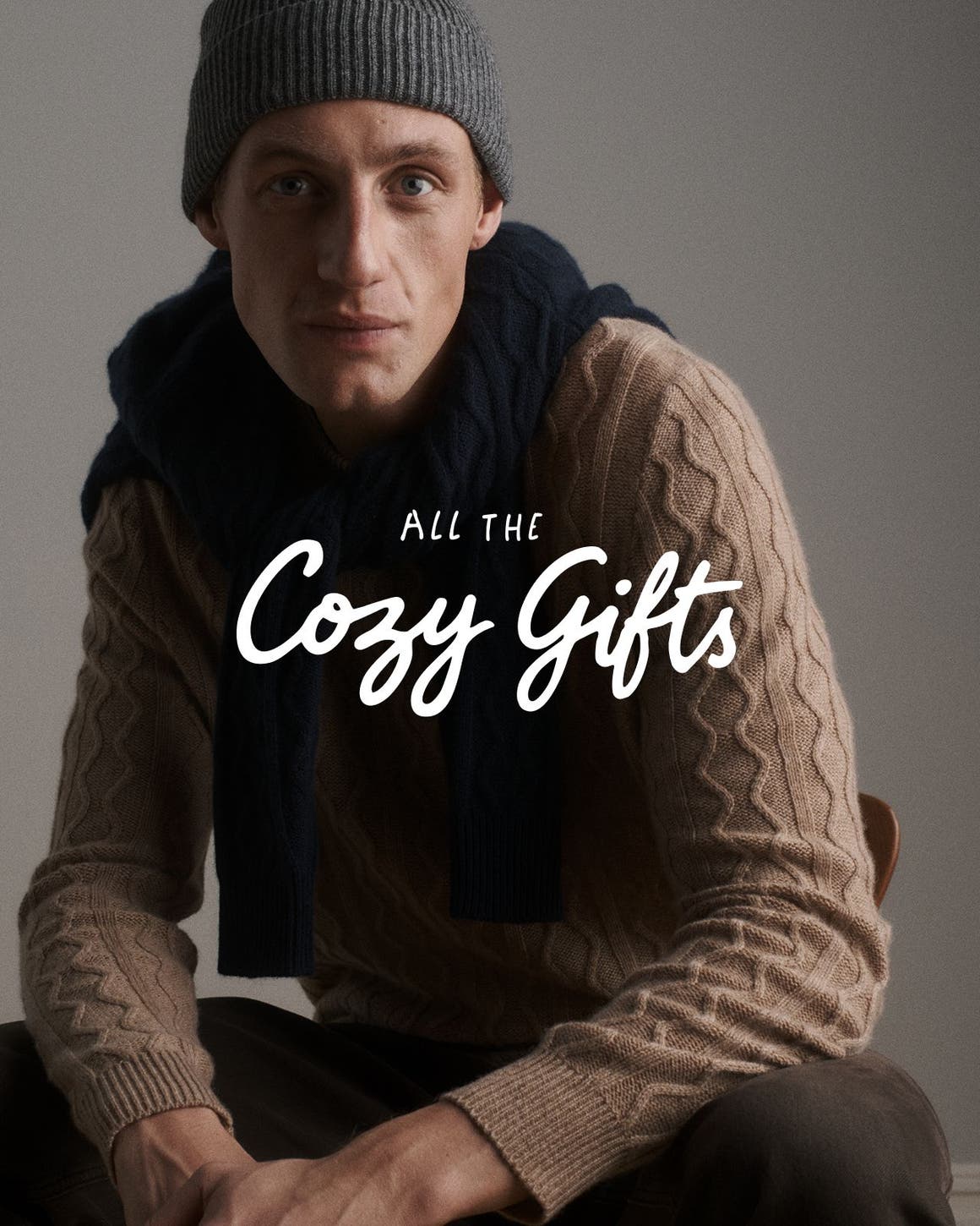 All the cozy gifts. A man wearing a cashmere sweater and accessories.