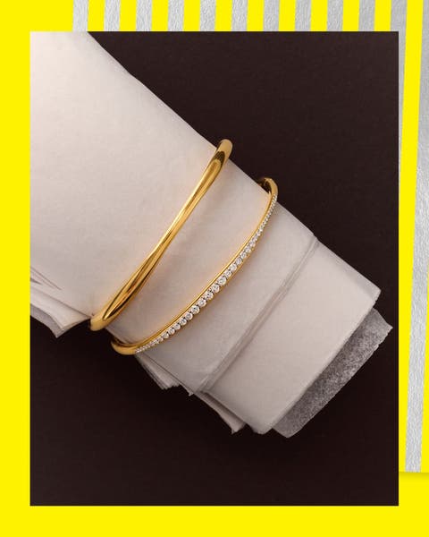 Gold bangle and diamond tennis bracelets.