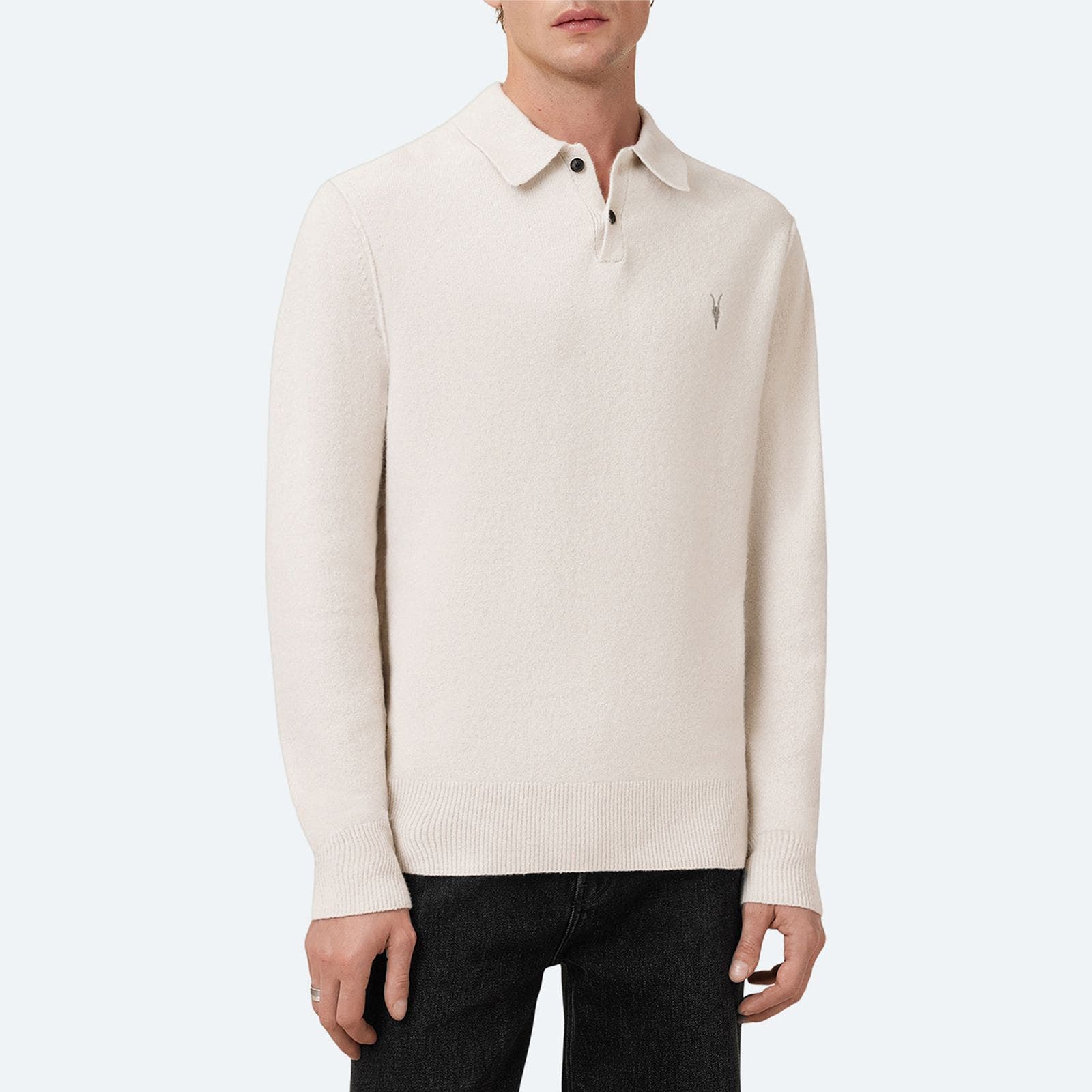 A man wearing beige sweater polo.