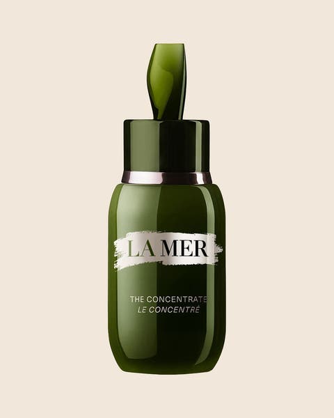 A La Mer The Concentrate serum in a green glass bottle with a silver band.