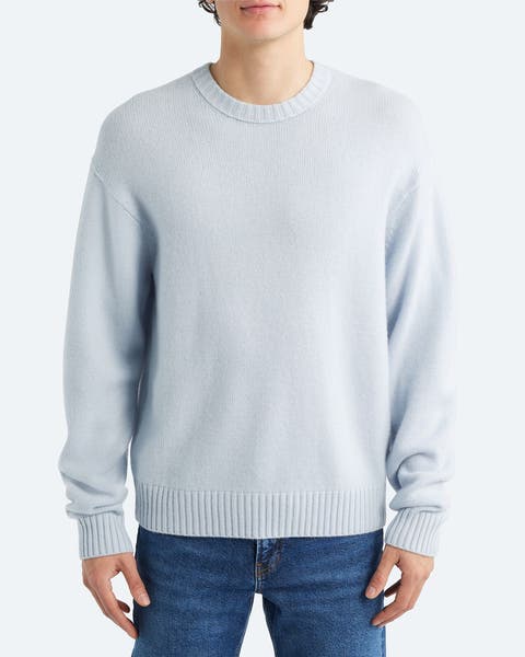 A man wearing light blue cashmere sweater.