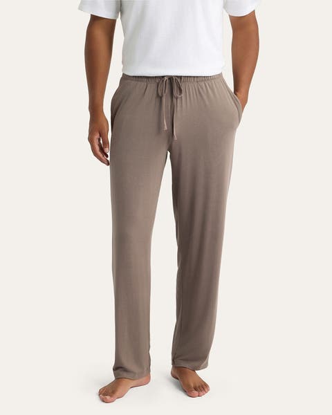 Image of man in white tee and brown sleep bottoms.