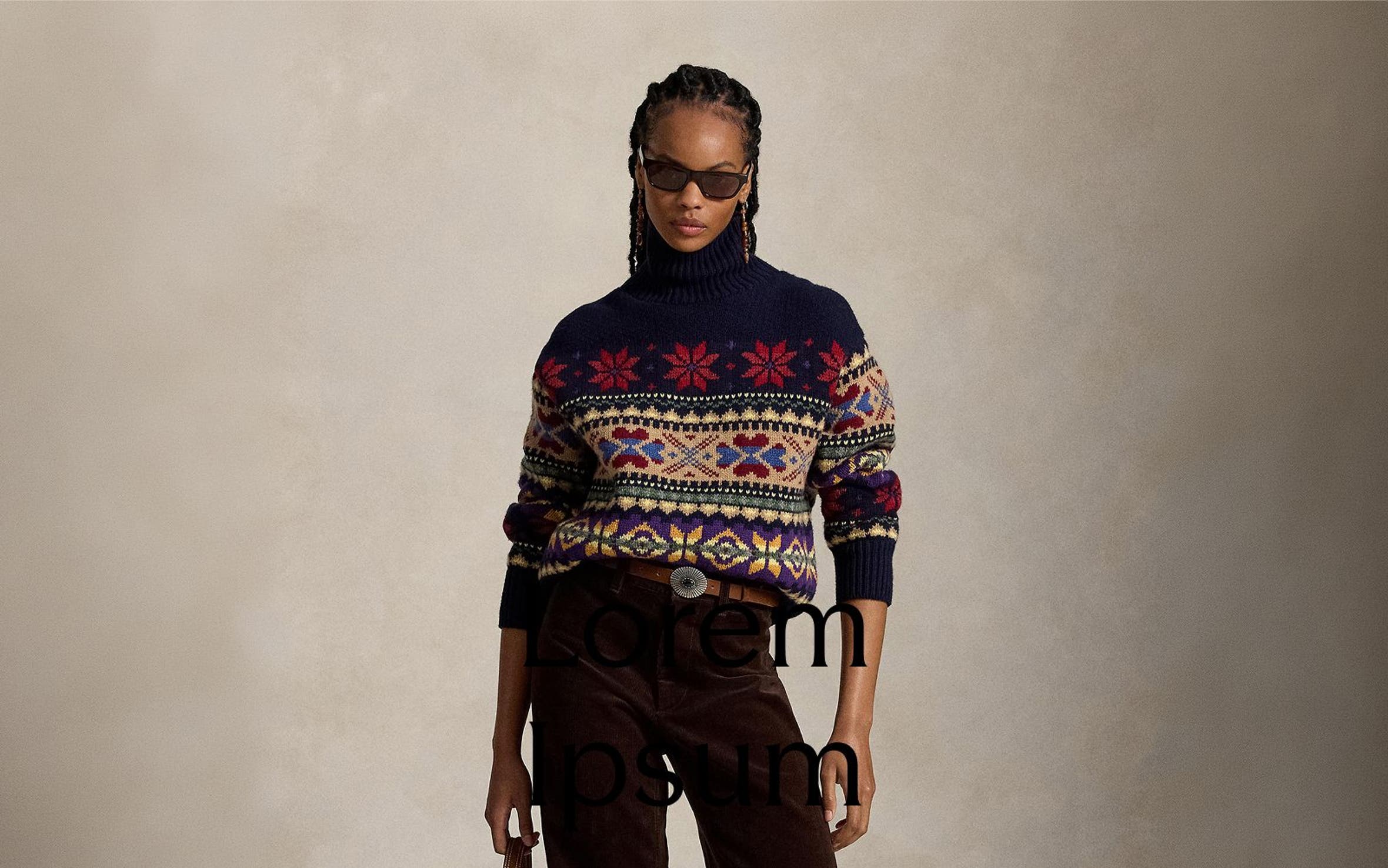 A woman wearing a fair isle sweater and dark brown corduroy pants.