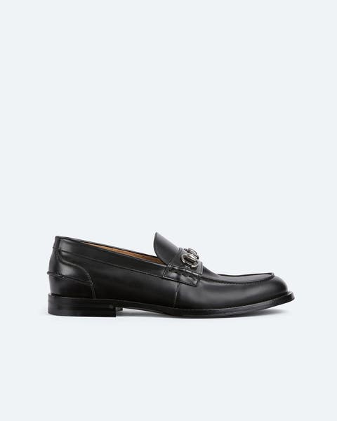 Black Gucci loafer.