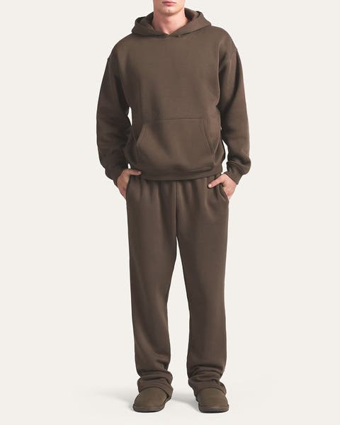 Image of man in brown fleece hoodie and sweatpants. 
