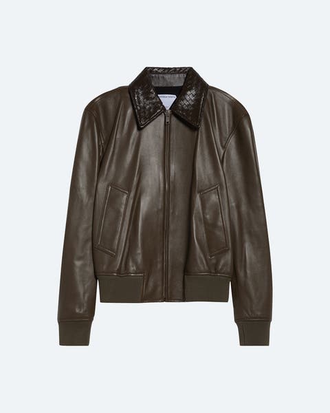 Dark brown leather jacket with a collared neckline, front zip closure, two front flap pockets, and ribbed cuffs and hem in a bomber-style silhouette