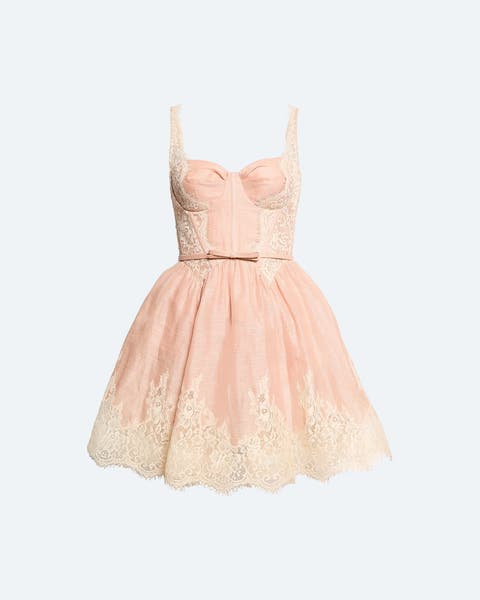 Pink corset-style mini dress with a bustier bodice, thin straps, cream lace and embroidered floral detailing at the bust and hem, a thin bow belt at the waist, and a full tulle skirt