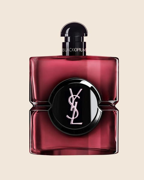 A Yves Saint Laurent perfume bottle in deep red glass with a black cap.
