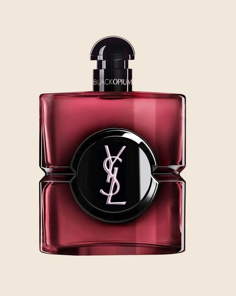 A Yves Saint Laurent perfume bottle in deep red glass with a black cap.