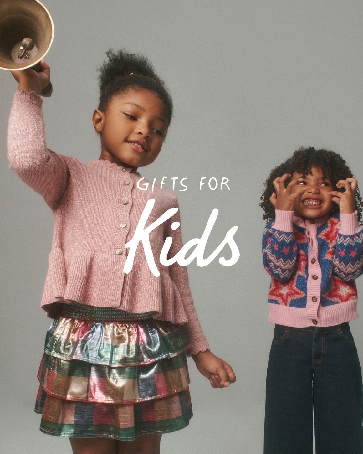 Gifts for kids. Two girls wearing cardigans.