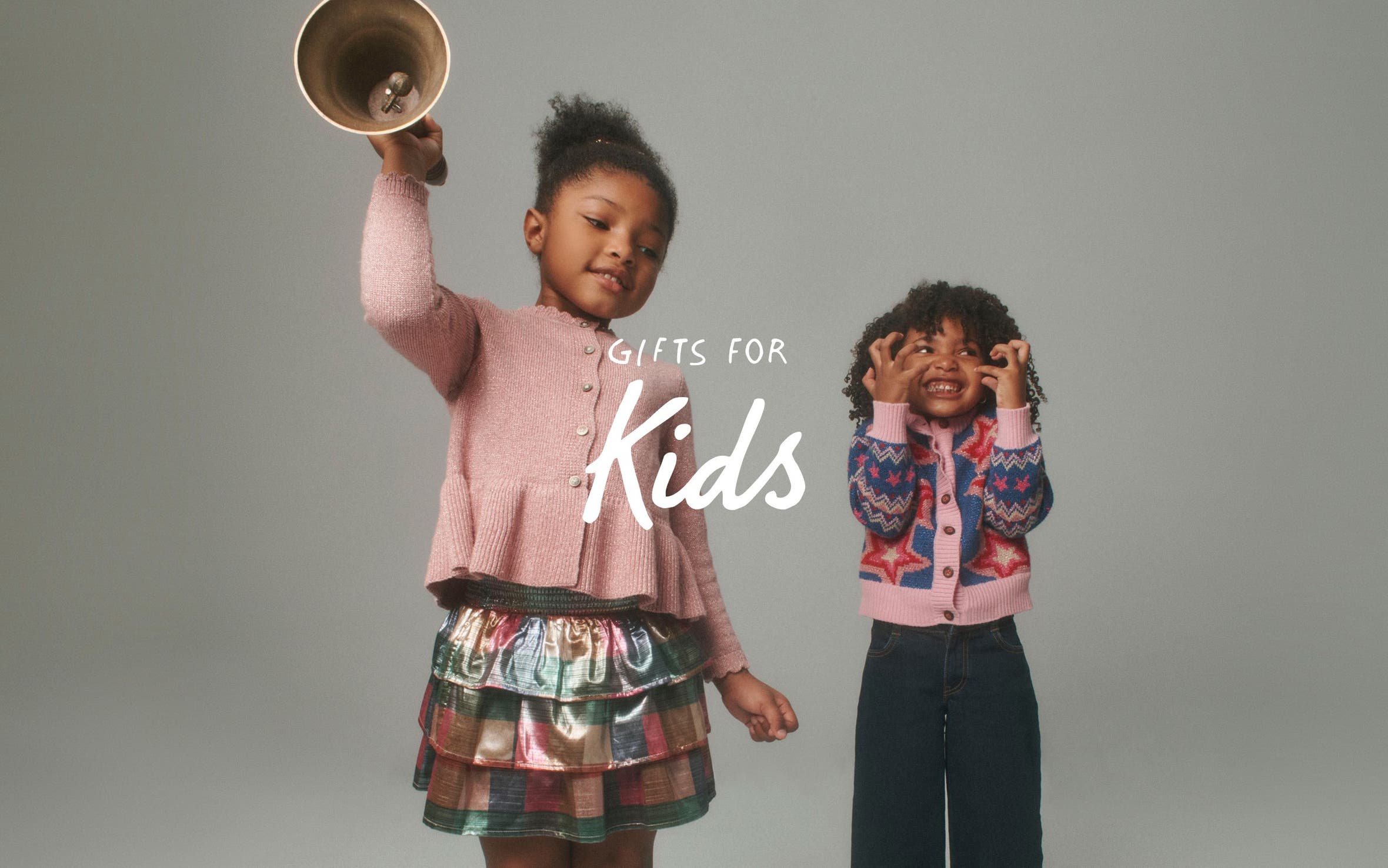 Gifts for kids. Two girls wearing cardigans.