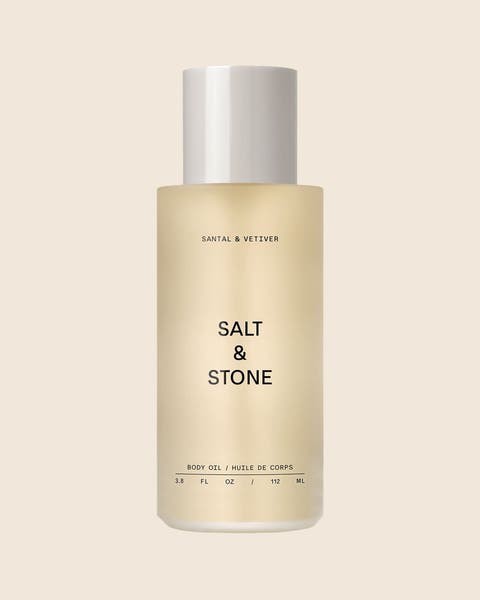 SALT & STONE Santal & Vetiver body oil in a clear bottle.