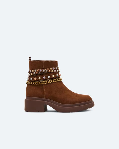 Brown suede booties with charm and chain details.