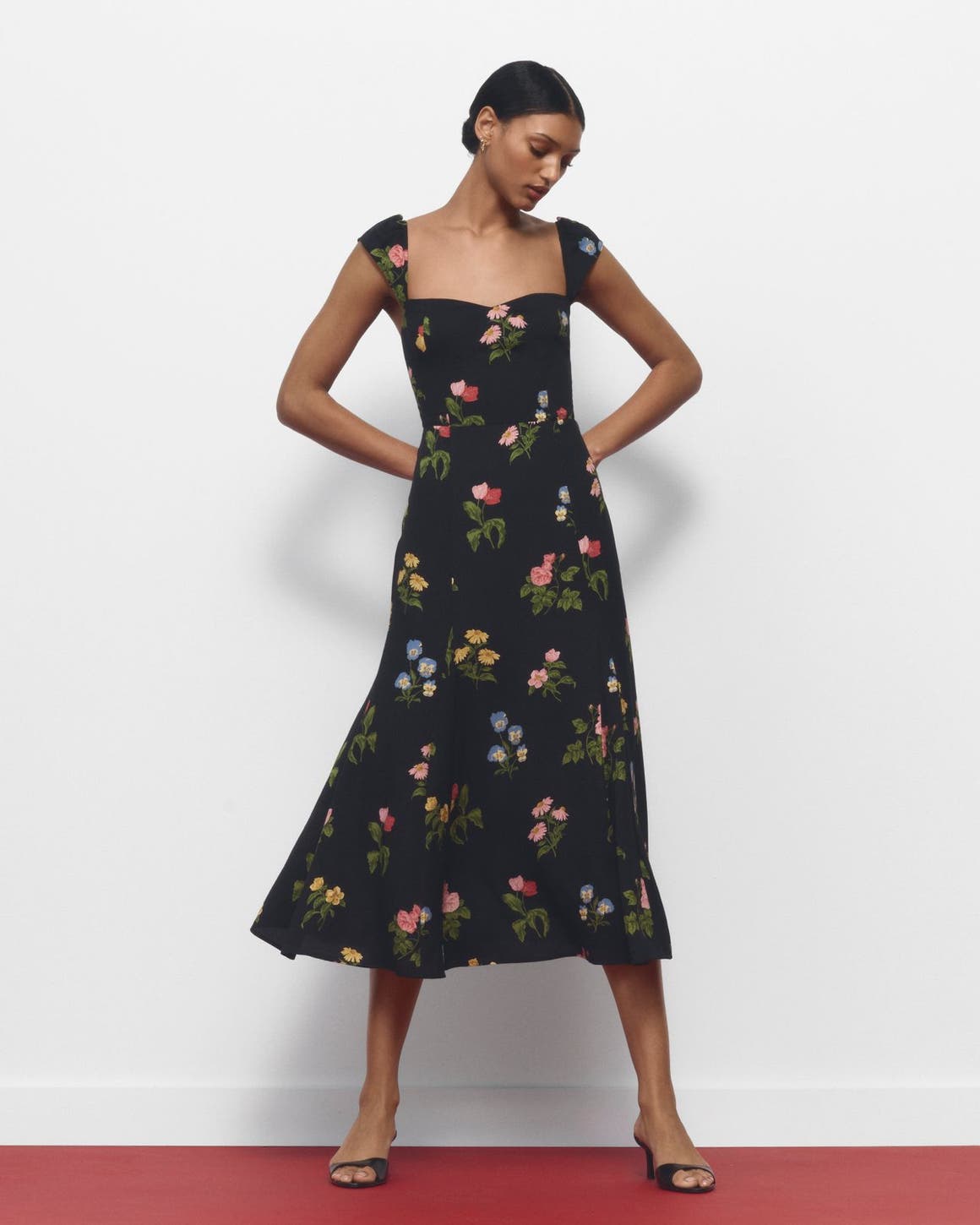 A woman wearing a floral-print dress.