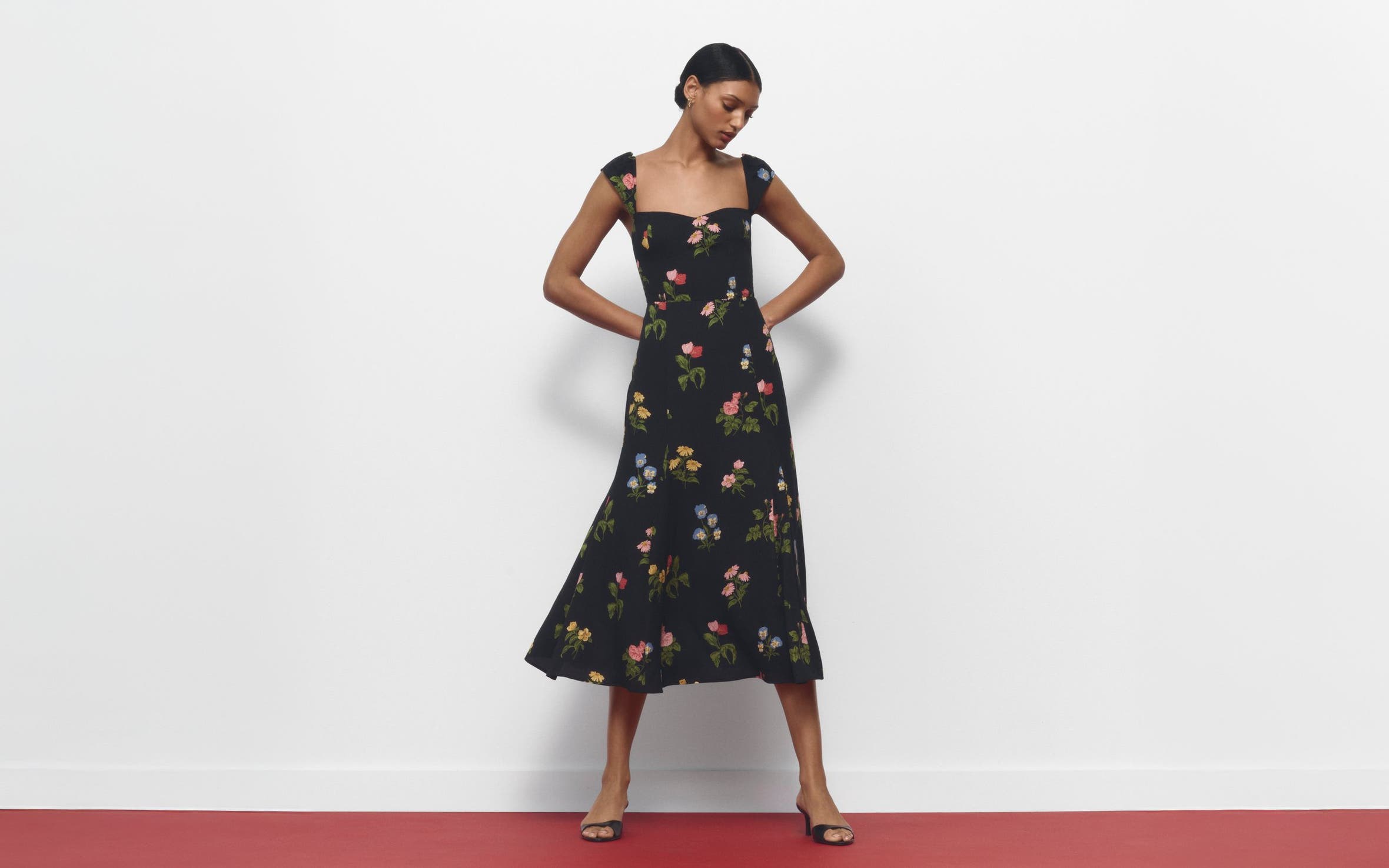 A woman wearing a floral-print dress.