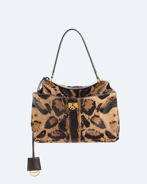 Leopard-print calf-hair handbag with a brown leather top handle and shoulder strap, gold-tone hardware, and a hanging leather charm detail.