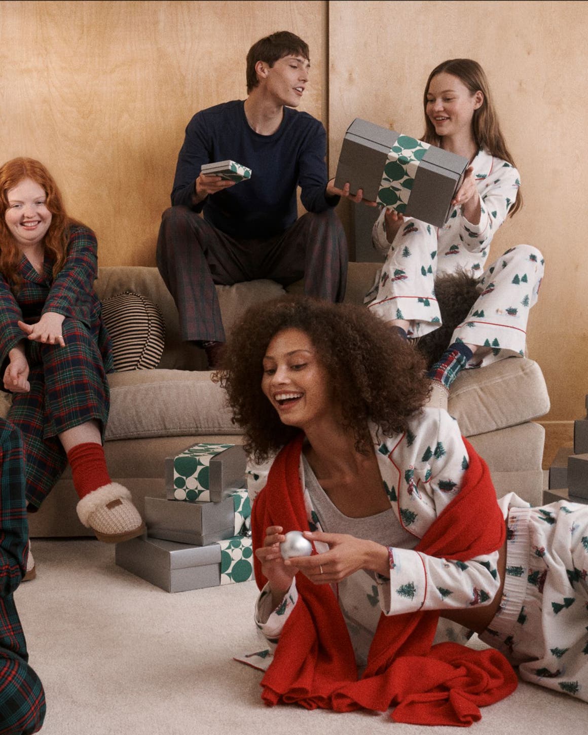 Men, women and kids in matching pajamas and slippers.