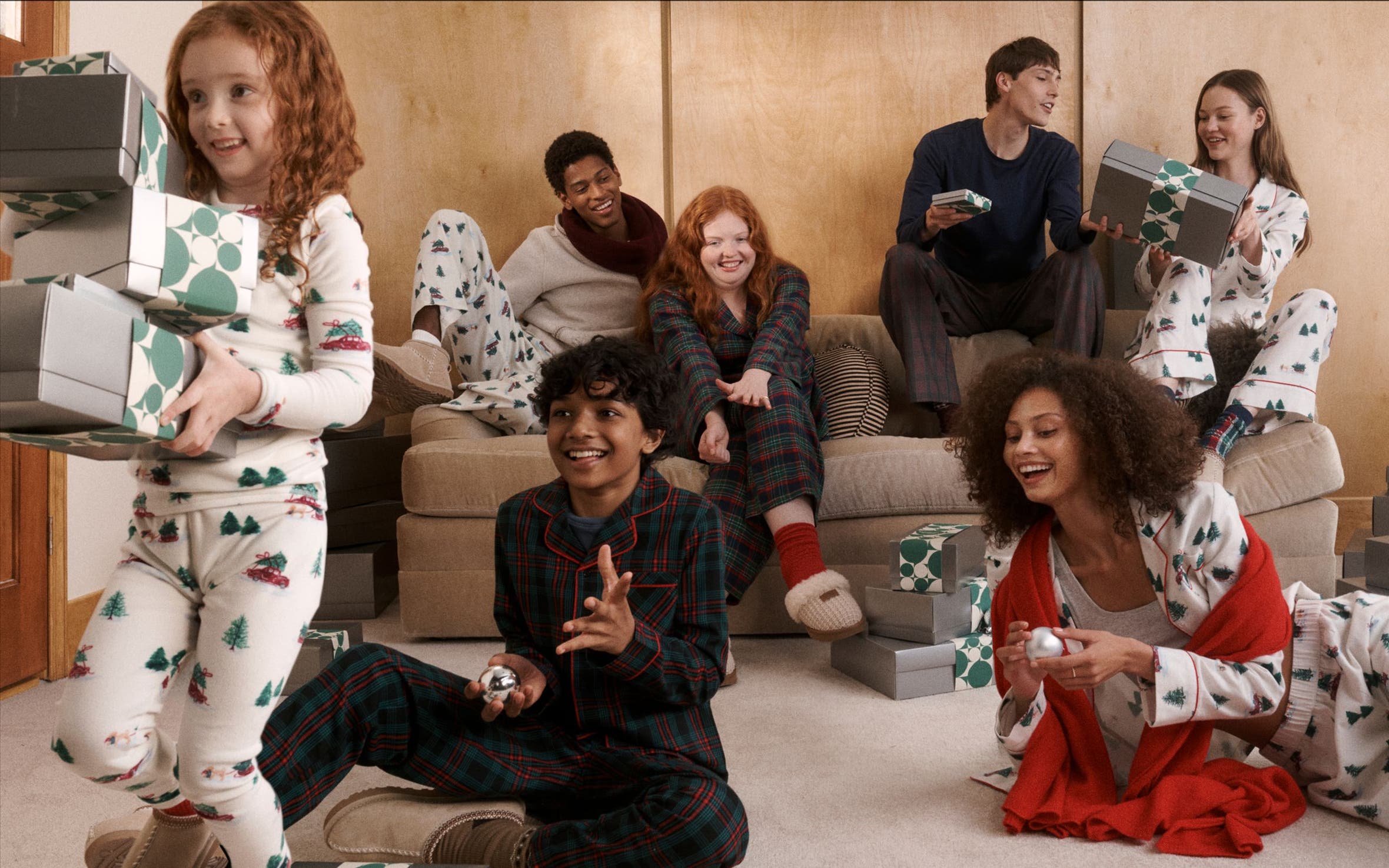 Men, women and kids in matching pajamas and slippers.