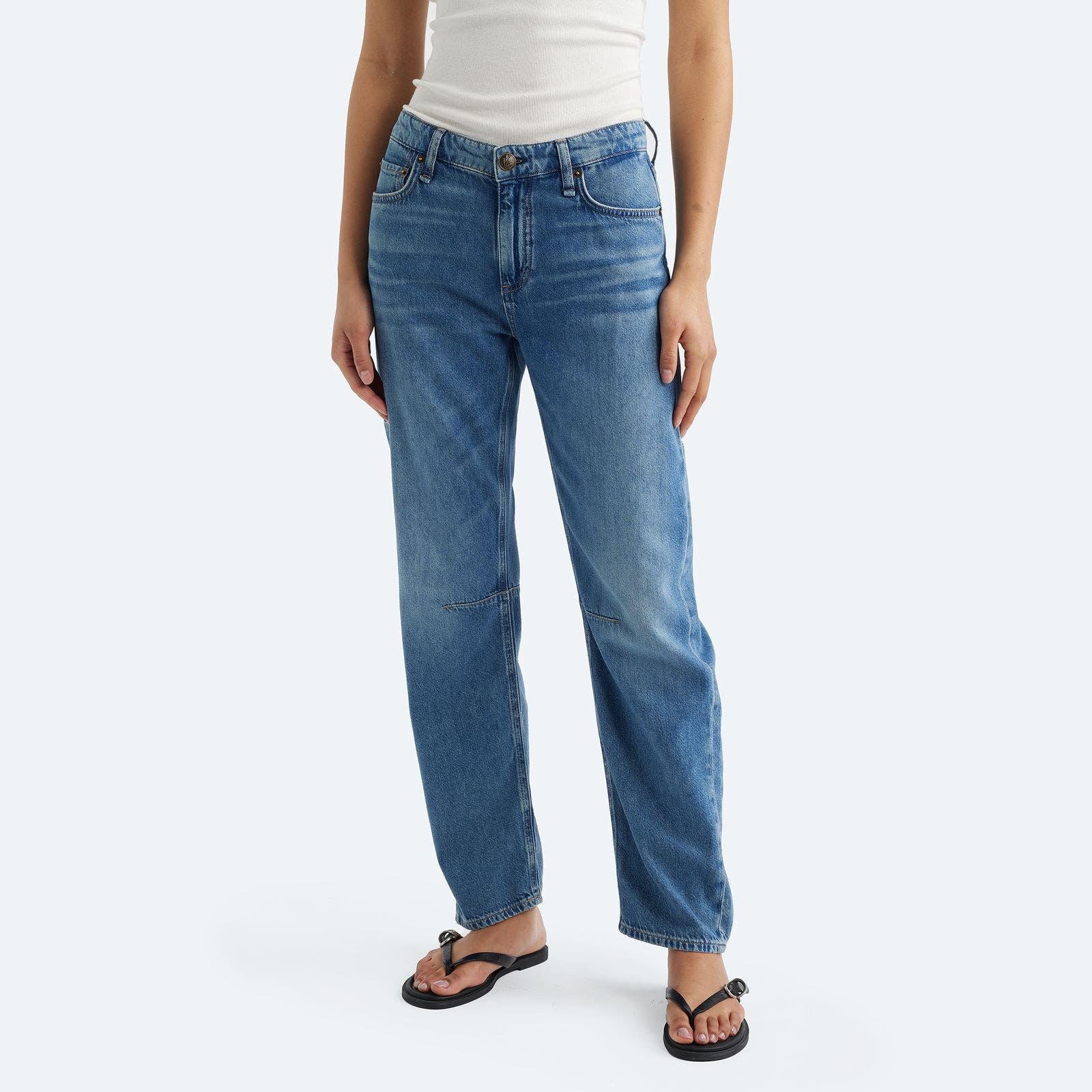 A woman wearing a pair of ankle jeans.