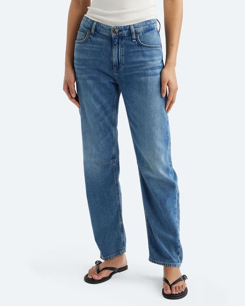 A woman wearing a pair of ankle jeans.