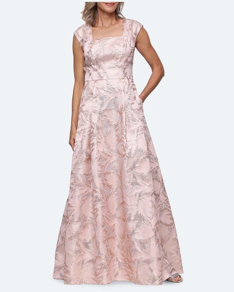 A woman wearing a pink sequin long a-line gown.
