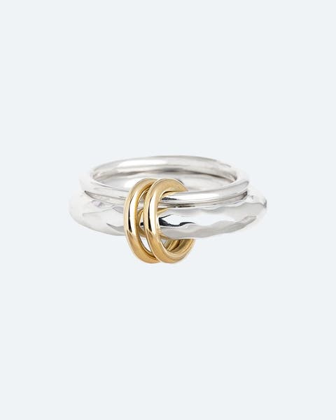 Stacked silver ring with gold bangle wrapping.