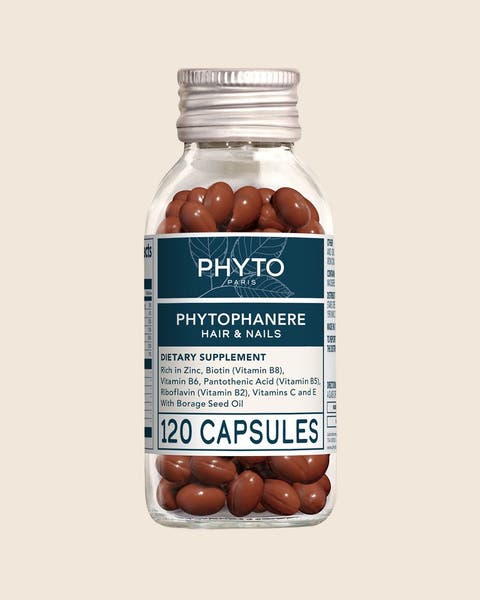 A PHYTO Phytophanere Hair & Nails supplement in a glass bottle with a silver cap.