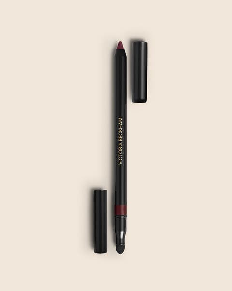 A Victoria Beckham eyeliner pencil in black with a deep burgundy tip and a smudger.