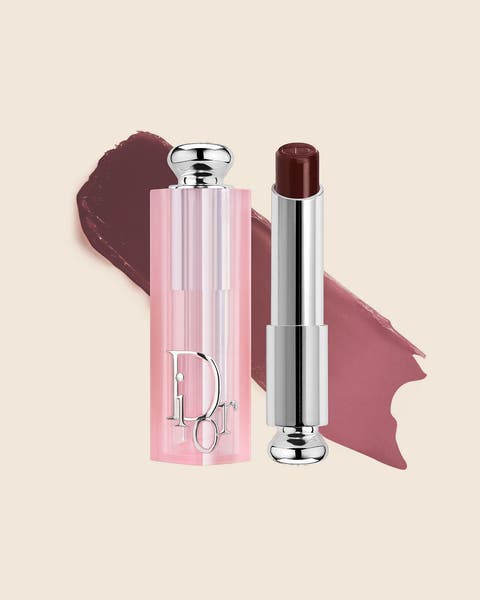 A pink DIOR lip balm with a deep berry bullet and a matching swatch.