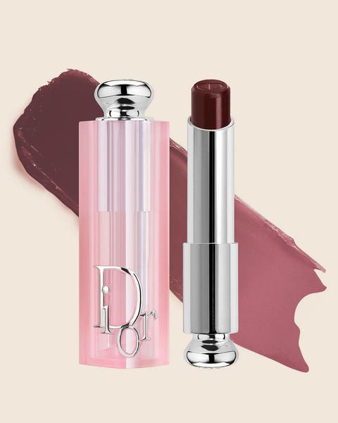 A pink DIOR lip balm with a deep berry bullet and a matching swatch.