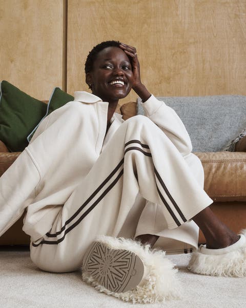 A woman wearing loungewear and slippers.