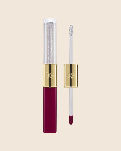 A Dolce&Gabbana dual-ended lip duo with a clear gloss, a berry liquid lipstick and two gold caps.