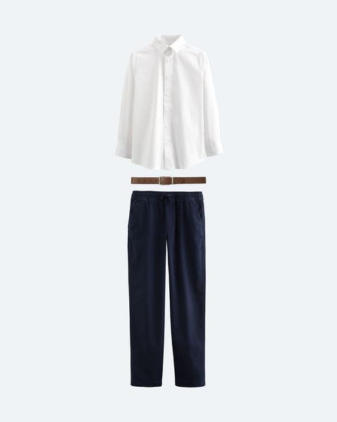 Navy chinos, white button-up shirt and brown leather belt.