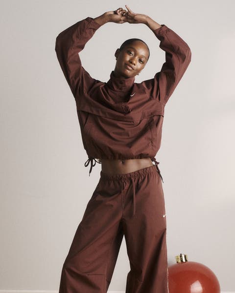 A woman wearing a track jacket and matching pants.
