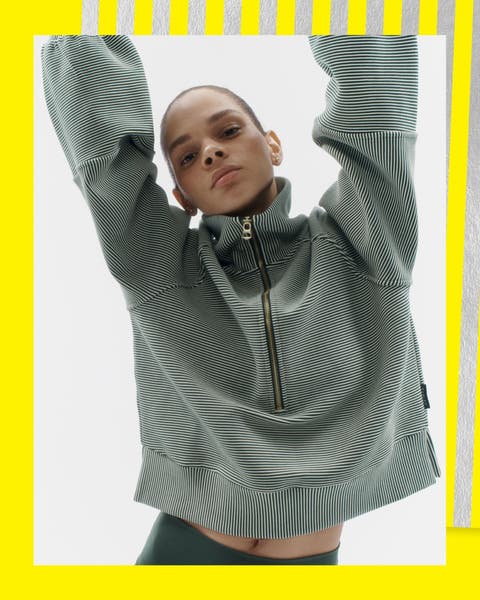 A woman wearing a half zip pullover.