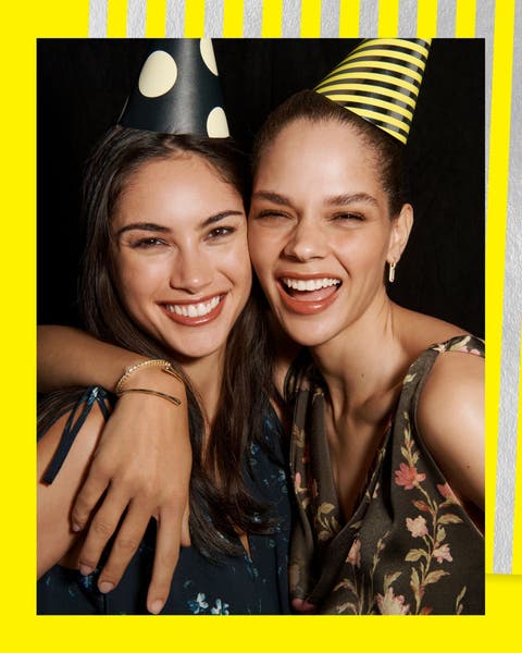 Two girls in party hats.