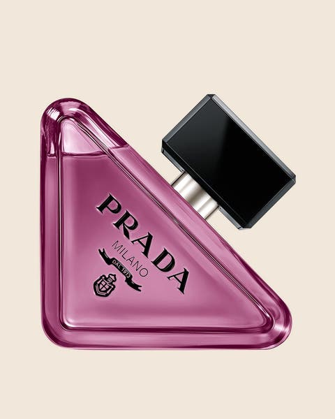 A Prada Milano fragrance in a purple triangle-shaped glass bottle with a black square cap.