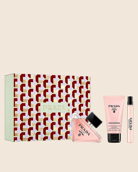 A Prada perfume set in a red, white and mint geometric gift box with a pink tube and a mini spray.