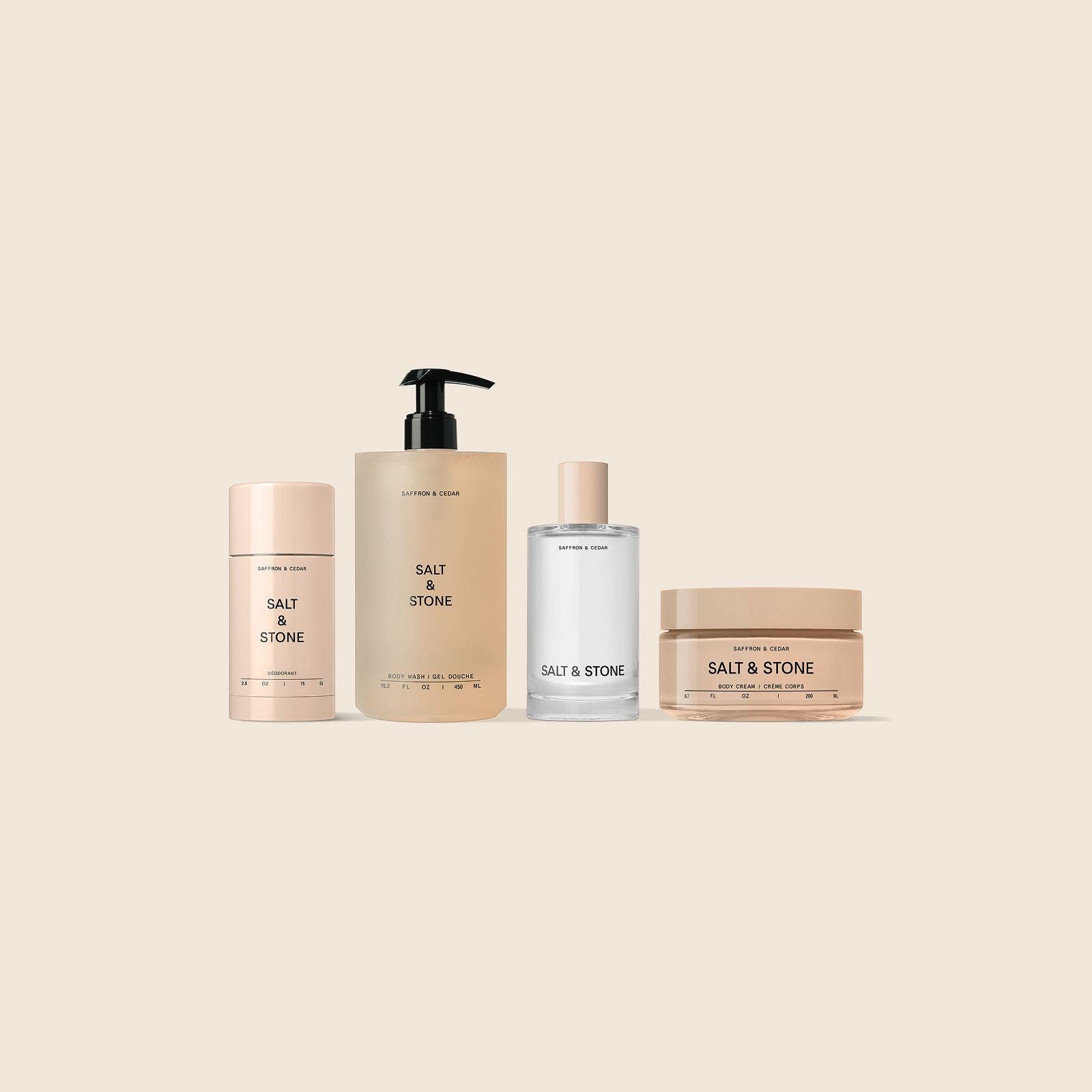 Four SALT & STONE body care products: a deodorant stick, pump bottle, fragrance and body cream.