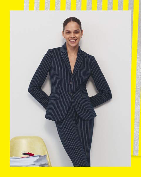 A woman wearing a pinstripe suit.