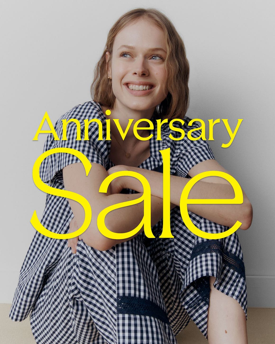Anniversary Sale: a woman in a blue and white gingham PJ set.
